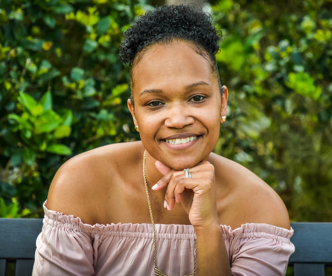 woman smiling resting her chin on her hand